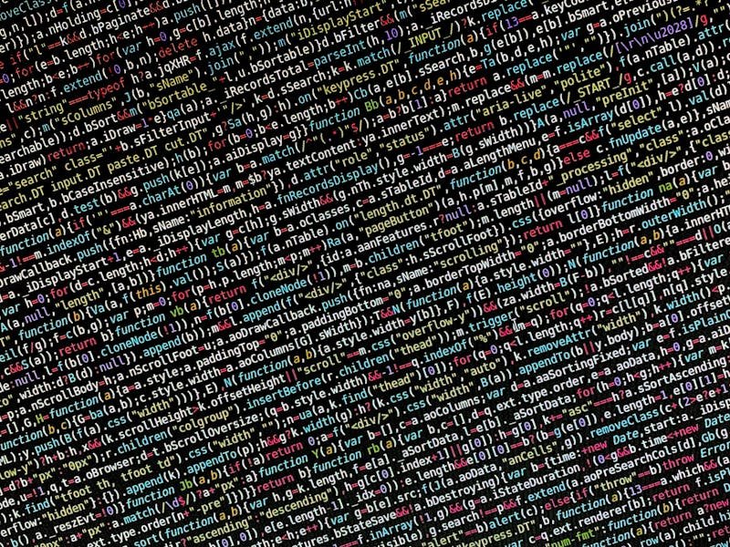 Close-up de código de programação algorítmica exibido em tela escura com sintaxe colorida